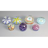 Seven assorted millefiori decorated glass paperweights