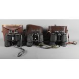 A pair of Scheffel 20 x 50 binoculars, in case, and two other cased pairs of 10 x 50 binoculars by