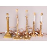 A brass Corinthian column table lamp, a pair of branch style brass lamps and another pair of brass