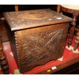 A carved oak slipper box with hinged lid, 18" wide