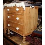 A Victorian waxed pine chest of two short and two long drawers with white china knobs, 33" wide