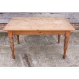 A pine kitchen table, on turned supports, 54" x 36"