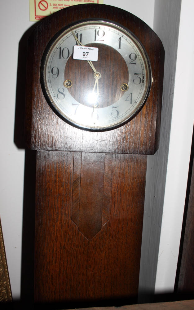 A mid 20th Century oak long case clock