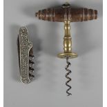 A brass corkscrew with turned wooden handle and a folding corkscrew advertising Goldtrack champagne