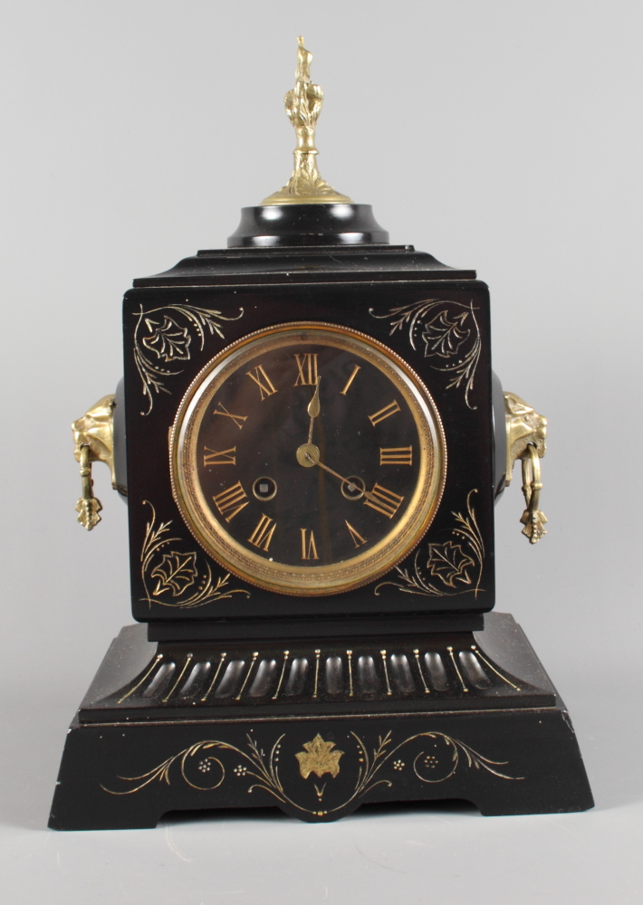 A 19th Century mantel clock in black slate case with gilt decoration, gilt metal finial and lion