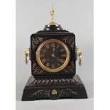 A 19th Century mantel clock in black slate case with gilt decoration, gilt metal finial and lion