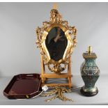 A cloisonne table lamp, a lacquered tray and a carved gesso Rococo style wooden mirror and two brass