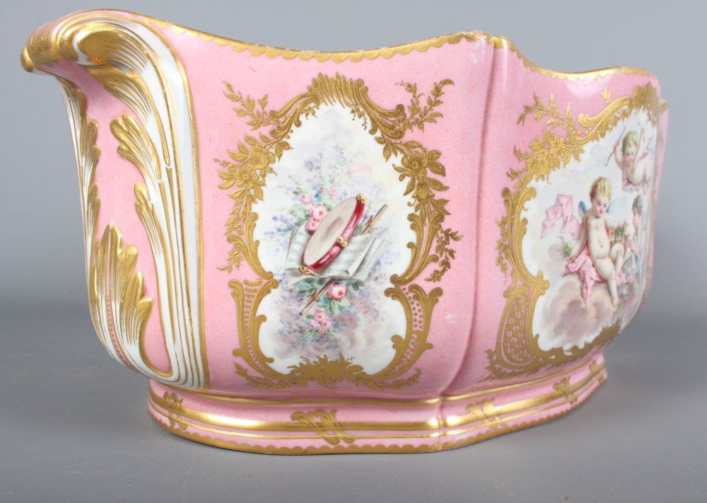 A Sevres porcelain jardiniere decorated reserves of flowers, putti and musical instruments on a pink - Image 3 of 8