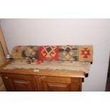 A kelim runner decorated stylised ornament with five red, natural and grey stripes, 151" x 28"