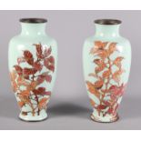 A pair of enamel on copper oviform vases decorated leaves, 11" high (damages), a pair of glass