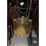 An Arts & Crafts wrought iron scrollwork and brass dinner gong