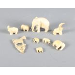 Eight carved ivory elephants, largest 1 3/4" high, and a carved bone model of a horse