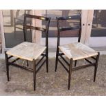 A pair of mid 20th Century ebonised rail back dining chairs and a 19th Century provincial rail