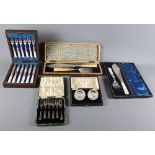Two pairs of silver plated fish servers, in fitted case, a cased set of dessert knives and forks,