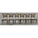 A set of six William IV rosewood dining chairs with rectangular framed backs and scroll carved "