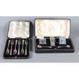 An Art Deco silver three-piece cruet set and a set of silver forks, both in boxes