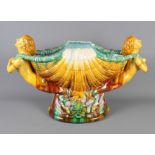 A majolica comport with central shell moulded bowl and two handles moulded as mermaids, 13" high