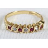 An 18ct gold seven stone ring set rubies and diamonds, size P