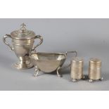 A miniature silver trophy cup and cover, a miniature silver cream jug and a pair of silver
