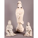 A Chinese porcelain blanc-de-chine figure of Kuan Yin, 19" high (restored), and two smaller