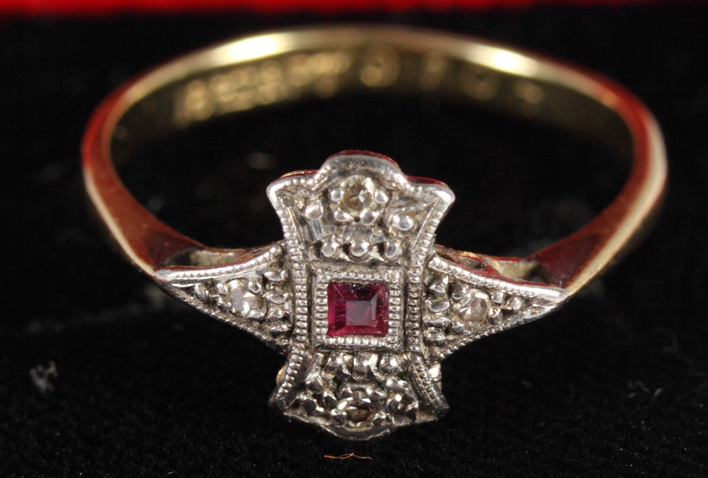 An 18ct gold ruby set ring and three silver rings