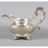 A Georgian silver milk jug with scrolled handle, 8.5oz troy approx