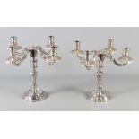 A pair of continental cast white metal four-branch candelabra, 10" high, 60.2oz troy approx