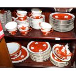 An oriental porcelain combination tea and dinner service decorated in red and gilt with key