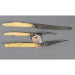 A three-piece carving set with ivory handles, carved as deer's feet, and silver ferrules