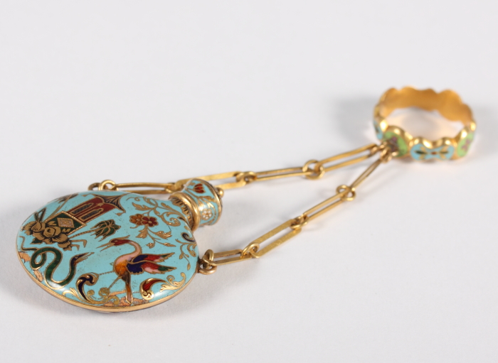 A gold and enamelled scent bottle, in the orientalist manner, with suspension chains and ring