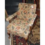 A late 19th Century walnut open armchair with down filled seat cushion, upholstered in a floral