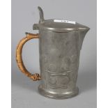 An Archibald Knox pewter hot water jug, pattern 0967