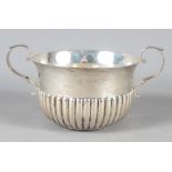 A Georgian style silver two-handled porringer, with half-fluted decoration, 4.1oz troy approx