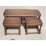 An Ercol 17th Century style nest of three elm coffee tables