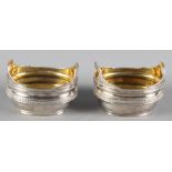 A pair of Georgian silver boat-shaped salts with reeded borders and gilt interiors