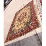 A modern Persian carpet decorated central floral medallion and spandrels on a beige ground with