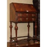 A William and Mary design walnut bureau, fitted two lower drawers, on turned supports and flat
