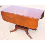 A 19th Century mahogany Pembroke table, fitted real and dummy drawers, on two turned central
