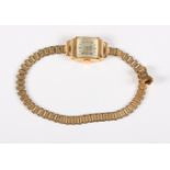 A ladies 18ct gold cased Wolux dress watch, on gilt metal bracelet