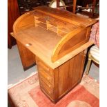 An oak single pedestal roll top desk, fitted four drawers, 36" long