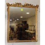 A 19th Century rectangular wall mirror, in gilt frame with scroll decorated top rail, 39" x 30"