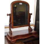 A Victorian mahogany framed arched top dressing mirror, on serpentine fronted base, 18" wide