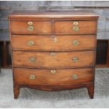 An early 19th Century mahogany bowfront chest of two short and three long drawers with oval brass