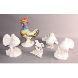 A Rosenthal porcelain bird, a pair of Royal Crown Derby white glazed birds and a porcelain cockerel,
