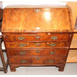 An early 18th Century walnut and herringbone banded bureau with sloping flap enclosing stepped