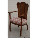 A Cotswold Arts & Crafts walnut elbow chair with panel back, on shaped supports