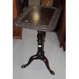 A Georgian occasional table with scroll and gadroon carved border, on adjustable column and tripod