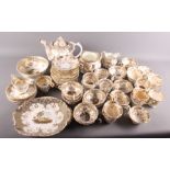 A 19th Century "Rockingham" style matched tea service decorated in grey and gilt (damages)
