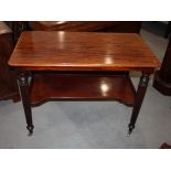 A 19th Century mahogany two-tier serving table, on turned and reeded supports fitted castors, 38"