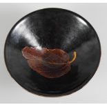 A Japanese pottery bowl, decorated leaves on a black background, 6" wide